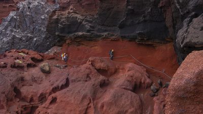 Conservation staff working on rocky island ground during the Desertas snail reintroduction