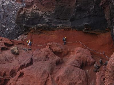 Conservation staff working on rocky island ground during the Desertas snail reintroduction