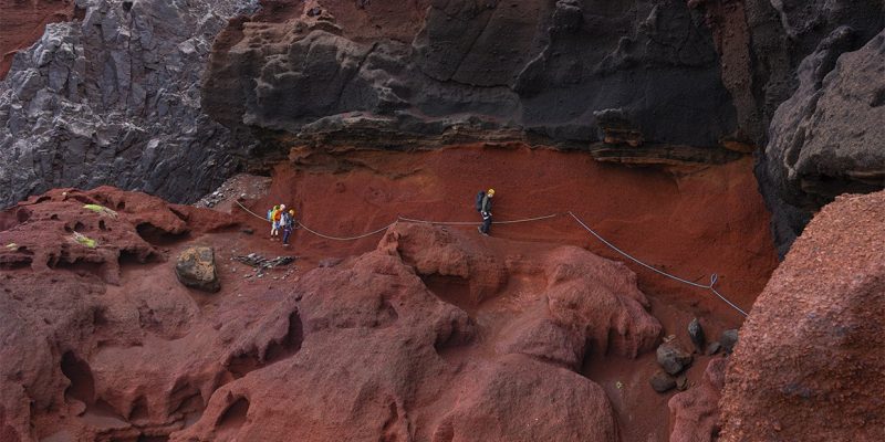 Conservation staff working on rocky island ground during the Desertas snail reintroduction