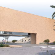 An architect's render of a long, low, sand-colored building with a wide open passage cut through its center, the word CETASEA in freestanding letters on the landscaping in front of it, palms and pine trees around it and a few small figures walking toward the entrance.