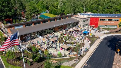 Aerial view of the Elmwood Park Zoo welcome center and veterinary health center with a crowd of visitors on the plaza below