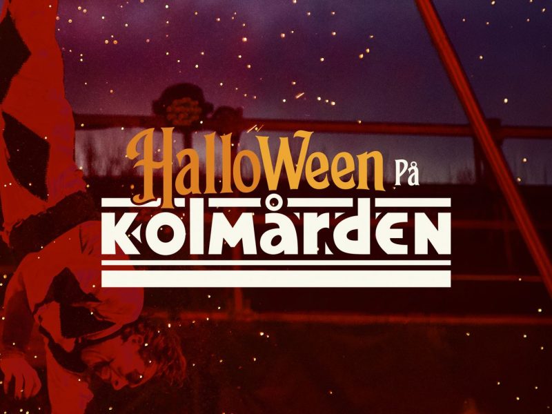 Promotional key art for Halloween at Kolmarden: a performer in a red and black harlequin costume hangs upside down from an aerial rig against a dark purple night sky lit with orange sparks, with the words Halloween pa Kolmarden set across the center in orange and white lettering.