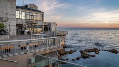 The Monterey Bay Aquarium's tide pool deck at sunset, with the open ocean to the right.