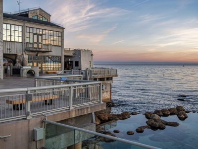 The Monterey Bay Aquarium's tide pool deck at sunset, with the open ocean to the right.