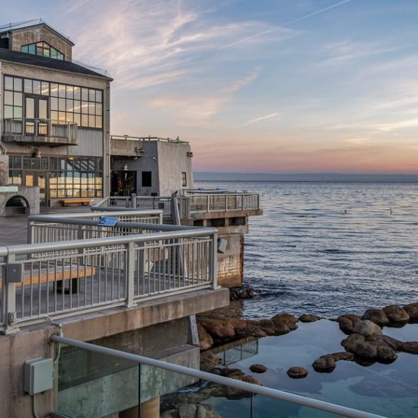 The Monterey Bay Aquarium's tide pool deck at sunset, with the open ocean to the right.