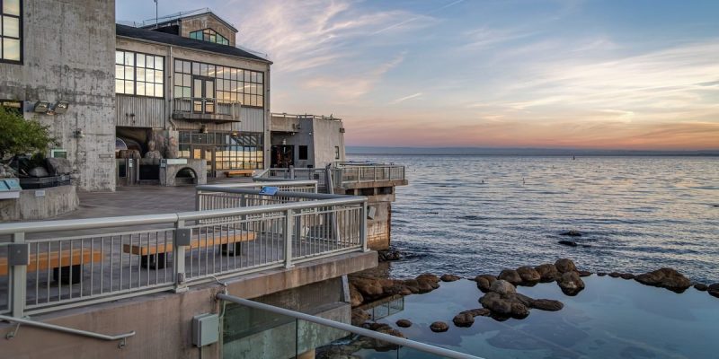 The Monterey Bay Aquarium's tide pool deck at sunset, with the open ocean to the right.