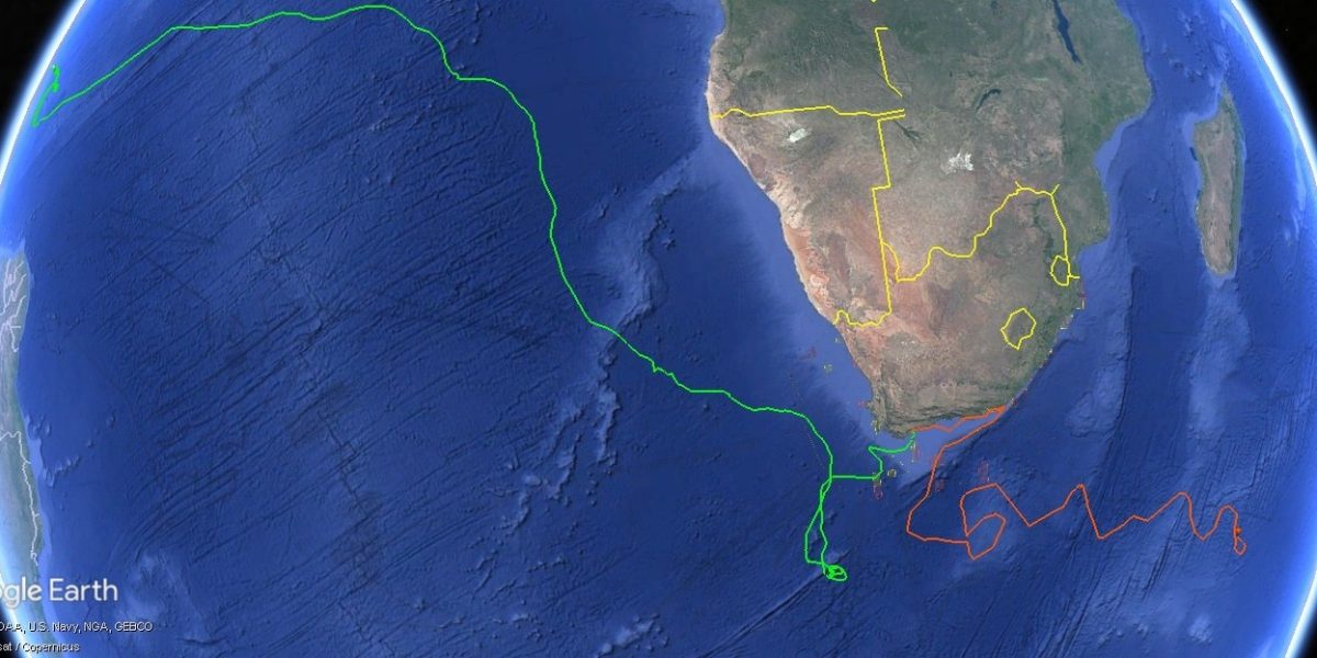 A satellite map of southern Africa and the surrounding oceans with two plotted tracks: a green line running from the southern Cape far up the Atlantic toward West Africa, and an orange line looping east from the Cape across the southwestern Indian Ocean.