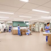 Architectural rendering of the Tennessee Aquarium's planned animal hospital: a bright treatment room with staff in blue scrubs, overhead surgical lights, teal cabinetry and a glass-walled imaging suite holding a CT scanner.