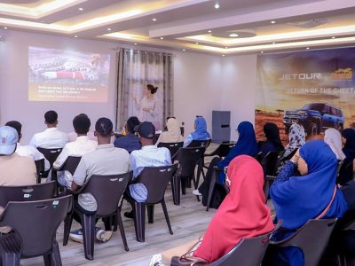 Rows of students sit facing a Cheetah Conservation Fund veterinarian who is presenting beside a projected slide reading, when an animal gets sick, is the problem only about that one animal, in a classroom at the CCF Somaliland campus near Hargeisa.