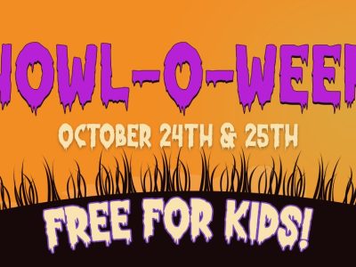 Promotional banner for Howl-O-Ween reading HOWL-O-WEEN, OCTOBER 24TH & 25TH and FREE FOR KIDS, in purple and green lettering on an orange sky, with black silhouettes of a goat in a witch's hat on the left and a rooster perched on the back of a horned animal wearing a crown on the right, above a dark grassy hill.