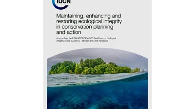 Cover of the IUCN technical report on ecological integrity, showing a split-level photograph of a small forested island in the Solomon Islands with the coral reef visible in the clear water beneath the surface.