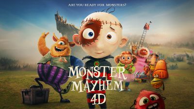 Promotional artwork for an animated film, showing a wide-eyed boy character stitched together from patches at center, a shaggy orange monster in purple striped trousers beside him and several smaller cartoon monsters across a green field, with a castle on a rocky crag behind. Lettering reads Monster Mayhem 4D and, above, Are You Ready For Monsters?