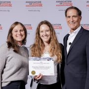 Cassandra Costello, Rochelle Stiles and Dan Ashe stand in front of an Association of Zoos and Aquariums backdrop, with Stiles holding the 2026 North American Conservation Award certificate for San Francisco Zoo and Gardens.